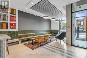 Toronto (South Riverdale) condo for rent - A modern waiting area with a bench, chairs, and pictures on the wall.