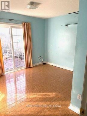 Toronto (Rouge) apartment for rent - A room with light blue walls and wooden flooring.