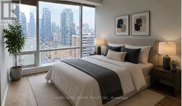 Toronto (Clairlea-Birchmount) condo for rent - A bedroom with a large bed and a view of the city.