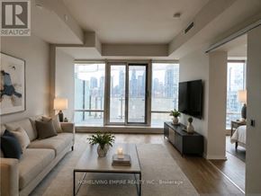 Toronto (Clairlea-Birchmount) condo for rent - A living room with a couch, a coffee table, and a flat-screen TV.