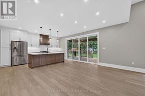 Innisfil (Alcona) apartment for rent - A modern kitchen with wooden floors and stainless steel appliances.