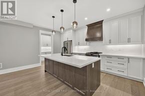 Innisfil (Alcona) apartment for rent - A modern kitchen with a white countertop and wooden cabinets.