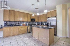 Markham (Cornell) apartment for rent - A kitchen with wooden cabinets and a tile floor.