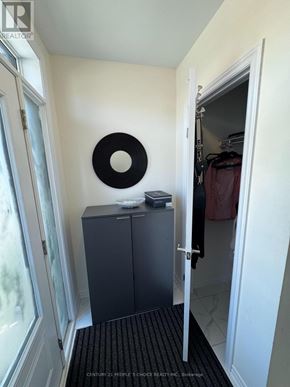 Barrie apartment for rent - A black and white circular object hangs on a white wall.