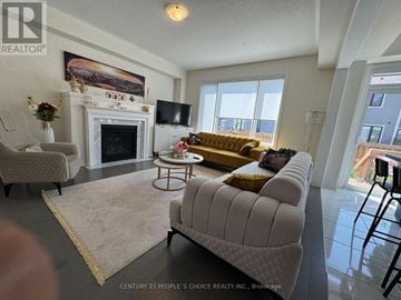 Barrie apartment for rent - A living room with a fireplace and a painting on the wall.