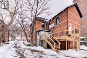 Barrie (North Shore) multi-family for rent - A red brick house with a deck and stairs.