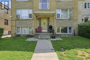 Toronto (Mimico) multi-family for rent - A brick building with a red chair in front of it.