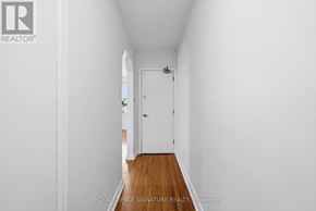 Toronto (Mimico) multi-family for rent - A white hallway with a door at the end.
