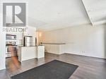 Toronto (Long Branch) townhouse for rent - A room with a black rug on the floor and a wall with a Pealton sign.
