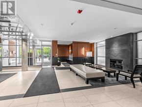 Mississauga (Port Credit) condo for rent - A modern waiting area with a bench, chairs, and a fireplace.