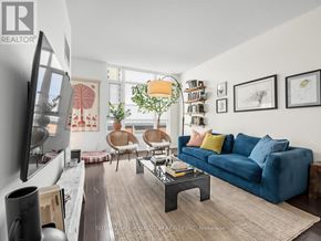 Mississauga (Port Credit) condo for rent - A living room with a blue couch and a television.
