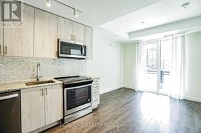 Oakville (Go Glenorchy) condo for rent - A kitchen with wooden cabinets and a stainless steel oven.