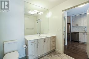 Oakville (Go Glenorchy) condo for rent - A bathroom with a toilet, sink, and mirror.