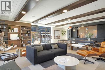 Kitchener condo for rent - A modern living room with a grey sofa and a coffee table.