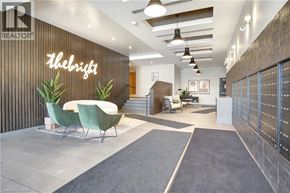 Kitchener condo for rent - A modern office lobby with a reception desk and green chairs.