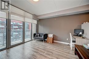 Waterloo condo for rent - A room with a desk and a couch with a box on the floor.