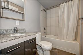 Waterloo condo for rent - A bathroom with a toilet, sink, and bathtub.