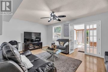 London East (East D) apartment for rent - A living room with a black leather couch and a flat screen TV.