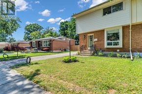 London East (East D) apartment for rent - A house with a white front door and a small front yard with a flower bed.