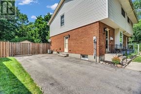 London East (East D) apartment for rent - A house with a driveway in front of it.