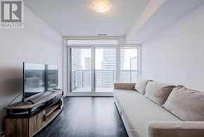 Toronto (Mount Pleasant West) condo for rent - A living room with a flat screen TV and sliding glass doors.