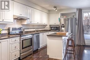 Toronto (Mount Pleasant East) duplex for rent - A kitchen with white cabinets and stainless steel appliances.