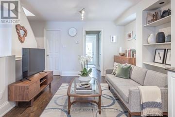 Toronto (Mount Pleasant East) duplex for rent - A living room with a grey couch and a wooden coffee table.