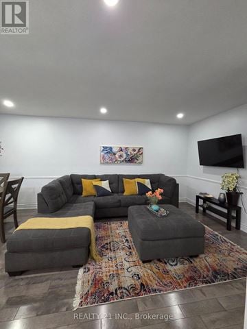 Toronto (Rouge) apartment for rent - A living room with a grey couch and a rug.