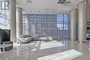 Richmond Hill (Langstaff) condo for rent - A modern living room with a large sectional sofa and a television.