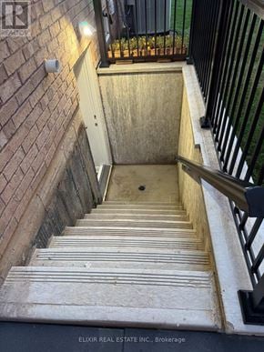 Burlington (Alton) apartment for rent - A staircase with a black railing and a brick wall.