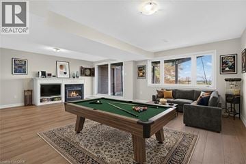 Stoney Creek townhouse for rent - A pool table is in the middle of a living room.