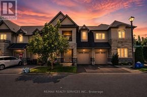 Hamilton (Mewburn) townhouse for rent - A house with a car parked in front and a tree to the left.