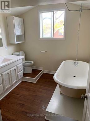 Cobourg apartment for rent - A white bathroom with wood floors and a claw foot tub.