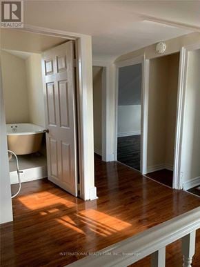 Cobourg apartment for rent - A bathroom with a tub and a doorway leading to another room.