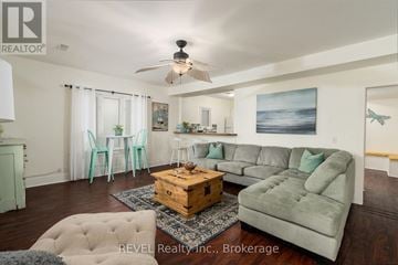 Fort Erie (Crystal Beach) apartment for rent - A living room with a grey couch and a wooden coffee table.