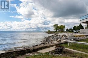 Fort Erie (Crystal Beach) apartment for rent - A beachfront property with a REVEL Realty Inc. sign in the foreground.