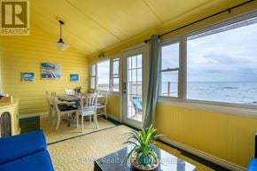 Fort Erie (Crystal Beach) apartment for rent - A bright yellow room with a table and chairs and a view of the ocean.