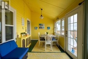 Fort Erie (Crystal Beach) apartment for rent - A sunny yellow room with a table and chairs.