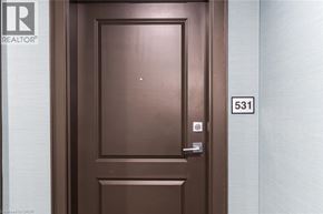 Waterdown condo for rent - A brown door with a silver handle and a number 531 on the wall.