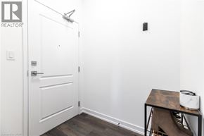 Waterdown condo for rent - A white door with a silver handle and a toaster on a table.