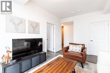 Waterdown condo for rent - A living room with a brown leather chair and a television.