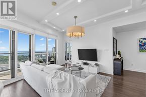 Toronto (Niagara) condo for rent - A modern living room with a large window overlooking the ocean.