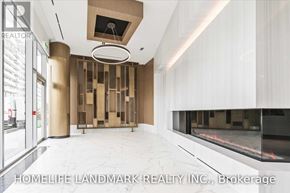 Toronto (Waterfront Communities) condo for rent - A modern interior space with a glass wall and a fireplace.