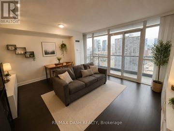 Toronto (Church-Yonge Corridor) condo for rent - A living room with a grey couch and a large window.