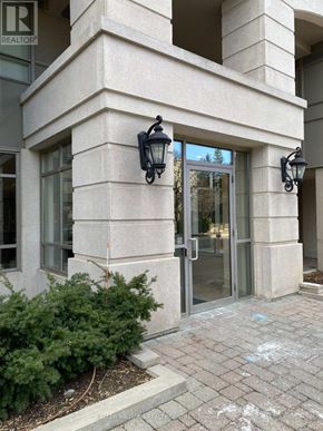 Toronto (Willowdale East) condo for rent - A building with a glass door and a sign that says REALTOR.