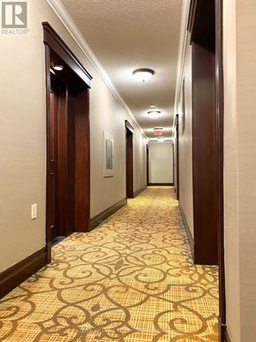 Toronto (Willowdale East) condo for rent - A hallway with a patterned floor and doors on either side.