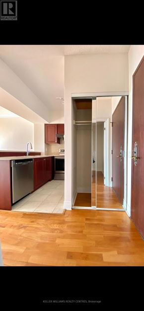 Toronto (Willowdale East) condo for rent - A kitchen with wooden floors and a refrigerator.