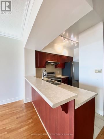 Toronto (Willowdale East) condo for rent - A kitchen with a marble counter top and wooden floors.