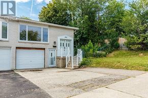 Toronto (Pleasant View) apartment for rent - A house with a white garage door and a grey door is surrounded by greenery.