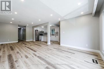 Toronto (Pleasant View) apartment for rent - A white kitchen with wooden floors and white cabinets.